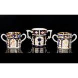 Loving Cups x 3 in the style of Royal Crown Derby, two small size and on larger size, white, blue