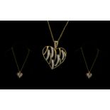 9ct Gold Heart Pendant And Chain In the form of an open heart with round brilliant cut diamond