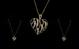 9ct Gold Heart Pendant And Chain In the form of an open heart with round brilliant cut diamond