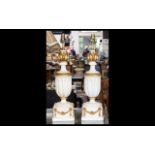 A Pair Of Neoclassical Style Lamp Bases cream and gilt finish of urn form with acanthus terminals,