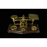 A Pair Of Postal Scales Of traditional form, together with four brass weights,