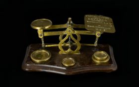 A Pair Of Postal Scales Of traditional form, together with four brass weights,