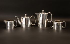 A Four Piece Plated Tea Service Of plain form comprising teapot, coffee pot,