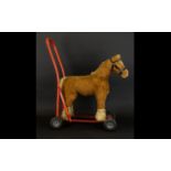 Tri-Ang Push Along Toy In The Form Of A Shire Horse Red metal frame with rubber wheels and