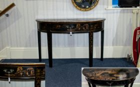 A Modern Oriental Black Lacquered Demi Lune Table Profusely decorated throughout with traditional