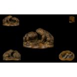 A Carved Fruitwood Netsuke In The Form Of A Pair Of Toads Finely carved with worm carved to base