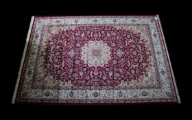 A Very Large Woven Silk Carpet Keshan rug with red ground and traditional Middle Eastern floral and