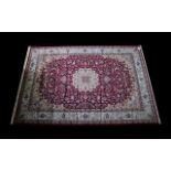 A Very Large Woven Silk Carpet Keshan rug with red ground and traditional Middle Eastern floral and