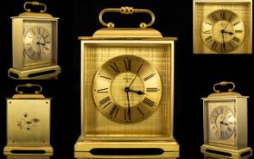 A Brass Travelling Clock Comprising gilt