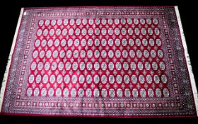 A Large Woven Silk Bokhara Carpet Ornate