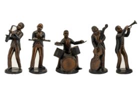 A Group Of Cast Metal Figurines In The F