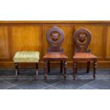 A Pair of Mahogany Hall Chairs each with turned legs and circular backs and shield form to centre,