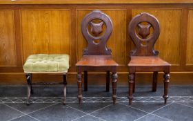 A Pair of Mahogany Hall Chairs each with turned legs and circular backs and shield form to centre,