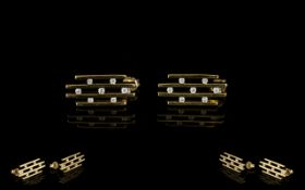 Pair Of 9ct Gold Diamond Earrings Modernist earrings each set with 7 round brilliant cut diamonds,