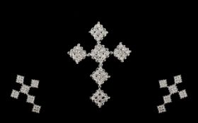 A 9ct White Gold Diamond Cross Fifty four round modern brilliant cut diamonds, mounted in the form