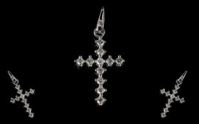 A 9ct White Gold Diamond Cross Set with 11 round brilliant cut diamonds, stamped 375, approx 25