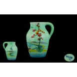 Clarice Cliff For Wilkinson One Handled Jug a turquoise ground jug with painted decoration of