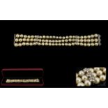 A Triple Strand Pearl Bracelet Comprising very well matched 7-8mm pearls, set between white gold