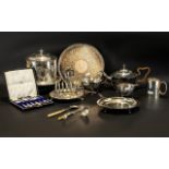 A Small Mixed Lot Of Antique Silver Plated Ware To include a three piece tea service of shaped form