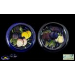 William Moorcroft Signed Pair Of Small Inverted Dishes 'Plums And Lemons' pattern on cobalt blue