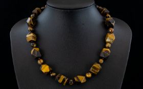 Tiger Eye Fancy Cut Bead Necklace, a strand of smoothly faceted cuboid tiger eye beads,