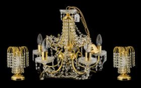 A Gilt Metal And Crystal Ceiling Pendant Five branch light fitting with gilt arts, cut glass column,