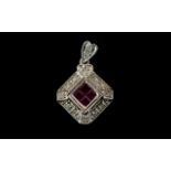 9ct White Gold Ruby And Diamond Set Designer Style Pendant Set with four calibre cut rubies