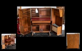 A Mid Century Teak Two Door Secretaire Of solid construct comprising two hinged doors,