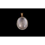 A 9ct Rose Gold And Diamond Set Pendant Oval form pendant set with shell pink opalescent cabochon,