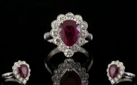 18ct White Gold Superb Pear Shaped Ruby And Diamond Cluster Ring Of stunning quality, the central