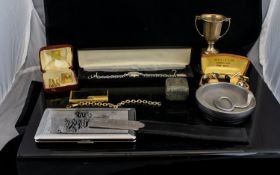 A Mixed Collection Of Oddments To include fashion watch, aluminium ashtray, cigarette case with