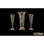Three Conical Form Silver Specimen Vases Each raised on circular base with embossed floral and