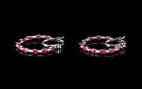 Ruby Hoop Earrings, a pair of fine hoops set with marquise cut rubies to both the front and inside