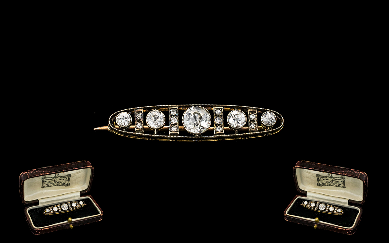 Early 20th Century Diamond Bar Brooch Set with a row of five graduating round cut diamonds between