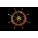 A Reproduction Ships Wheel Of typical form with brass inlay and mounts, diameter 24 inches.