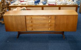 A Mid Century Teak Sideboard Of Typical form,