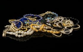 A Mixed Collection Of Costume Jewellery To include several strand of faux pearls, beads,