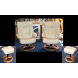 A Pair of Contemporary Leather Easy Chairs each raised on swivel base with height adjusters and