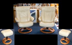 A Pair of Contemporary Leather Easy Chairs each raised on swivel base with height adjusters and