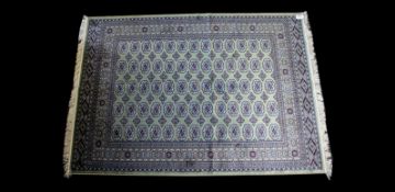 A Large Woven Silk Bokhara Carpet Ornate silk carpet with traditional lozenge and geometric repeat