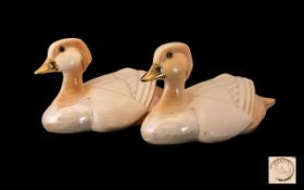 A Pair Of Art Deco Style Mandarin Duck Figures Each set amber glass eyes,