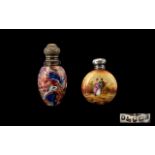 Two Antique Silver Topped Scent Bottles The first of circular flask form in ceramic with painted