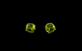 Pair of Peridot Stud Earrings, a pair round cut peridots of 1.