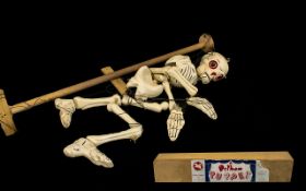 A Pelham Puppet In The Form Of A Skeleton Detaching Limbs And Lifting Head. Needs To Be Untangled.