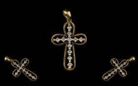A 9ct Gold Diamond And Diamond Set Cross Set with eleven princess cut diamonds, fully hallmarked,