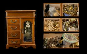 A Mixed Quantity Of Costume Jewellery Housed in a wooden jewellery box with glazed door,