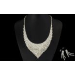 White Austrian Crystal Necklace and Earrings, a bib necklace with articulated sides and a V shaped