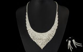 White Austrian Crystal Necklace and Earrings, a bib necklace with articulated sides and a V shaped