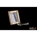 A Small Silver Picture Frame Boxed modern frame with bead and shell border,
