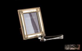 A Small Silver Picture Frame Boxed modern frame with bead and shell border,